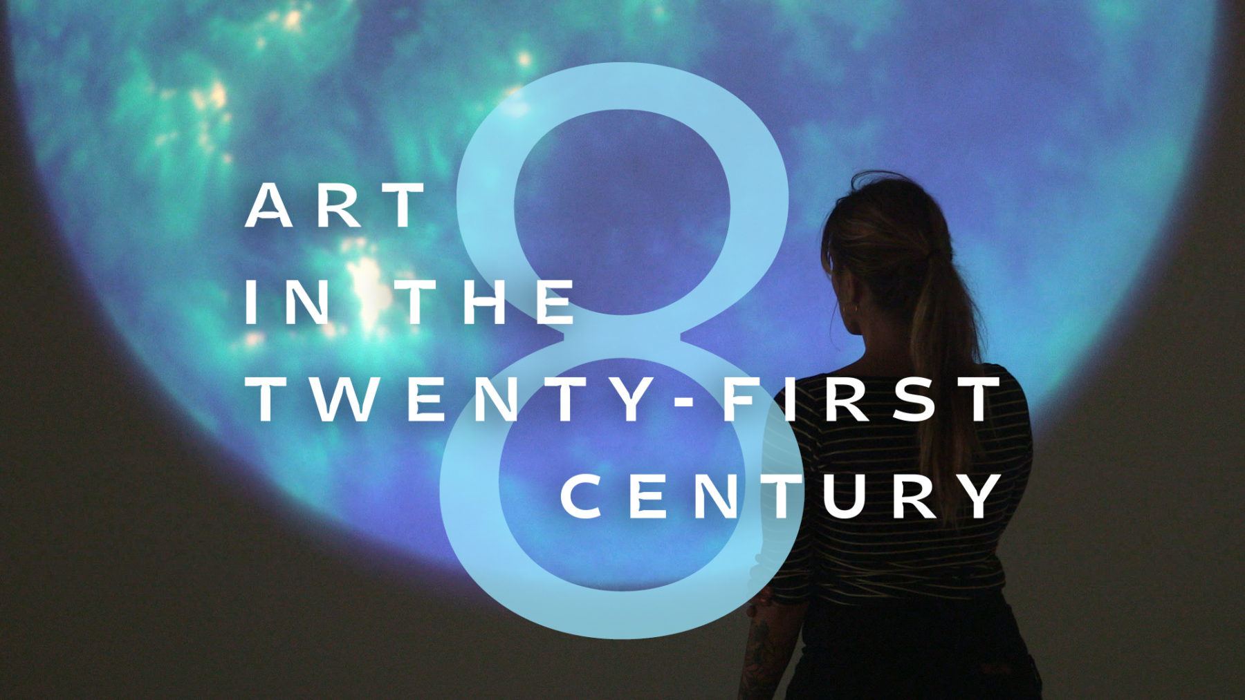 Art in the Twenty-First Century promotional picture with a person with long hair looking at a nebulous blue-green projection on a wall