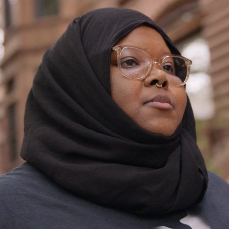 Three quarter angle portrait of Kameelah Janan Rasheed looking off camera.