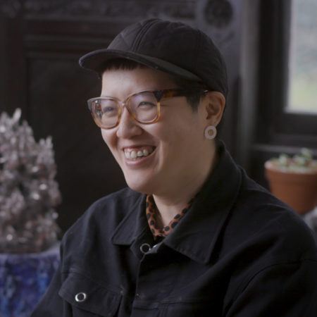 Heid Lau wearing a black cap in her studio at Green-Wood Cemetery