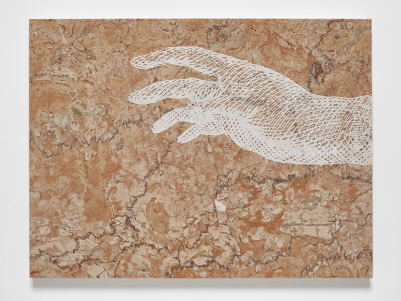 A beige and brown marbled surface features a white, intricate hand with outstretched fingers.