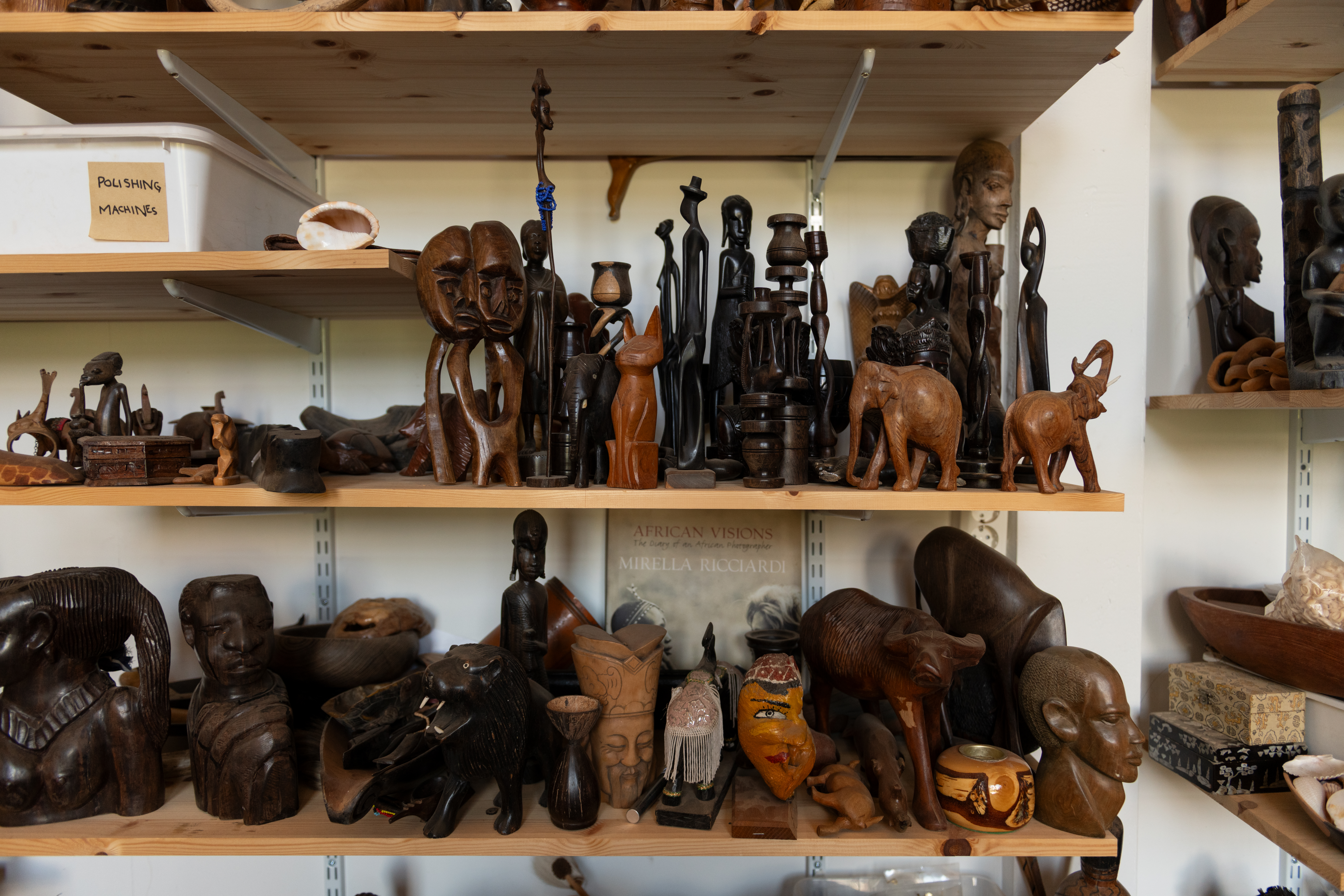 Images of African souvenirs on a shelf.