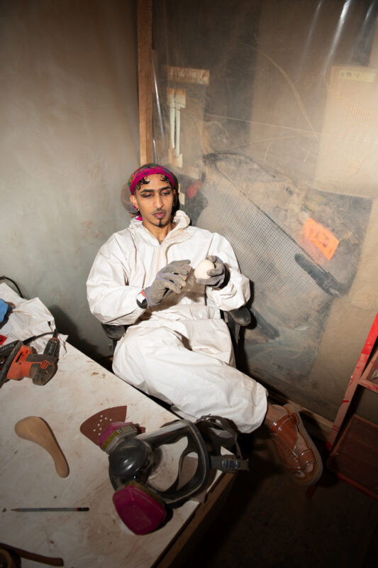 Artist sitting in his studio.