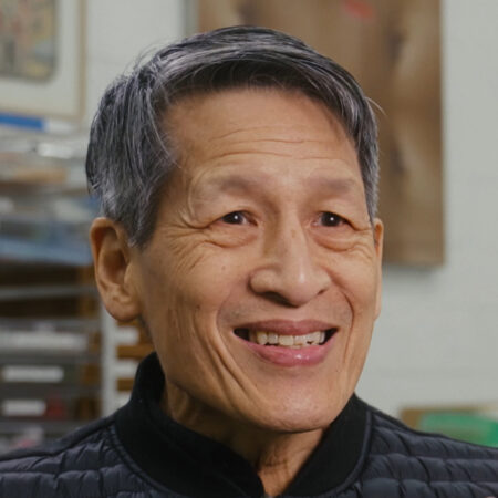 Headshot of Tishan Hsu with gray hair smiling.